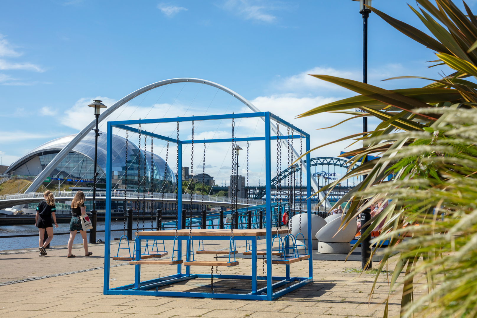 A large blue swing seat on Newcastle's Quayside